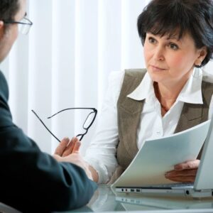 A woman is talking to an older man
