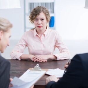 A woman sitting at a table with two other women.